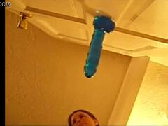 Alexis enjoys solo play with blue dildo on the door