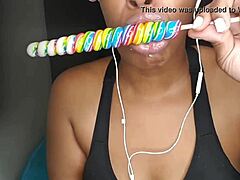 cute ebony chick sucking lollipop