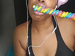 cute ebony chick sucking lollipop