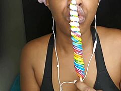 cute ebony chick sucking lollipop