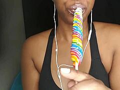 cute ebony chick sucking lollipop