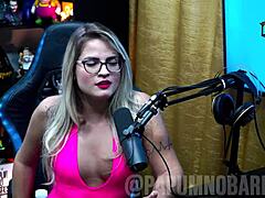 Bruna Carlos shows natural tits and arches ass for presenter.