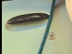 Brunette Washing Car with Hose Bath