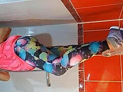 She pees and masturbates with dildo in gym shower