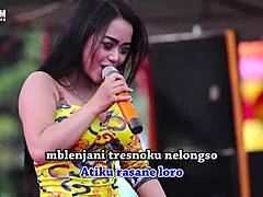 Indonesian erotic dance with two wild singers captivating a male crowd on stage.