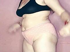 Puja tančí nahá v domácím videu. Její hubená postava a kamarádka se připojují, jak se ladně pohybuje s hudbou.