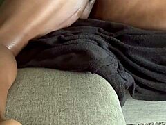 Having fun masturbating on the oiled sofa.