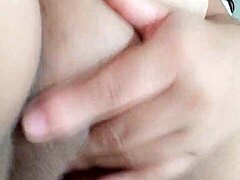 she fingers her dripping pussy on the bed.