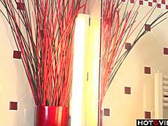 A blonde woman masturbates by fingering herself in the bathroom.