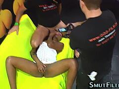 Ebony woman receives facial in bizarre scene.