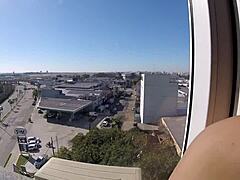 Sarada naked at hotel window near airport. Voyeur watches creampie scene.