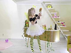 petite girl in bee costume enjoys treats