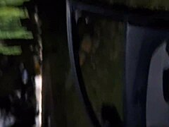 La esposa se pone en la ventana del auto, llamando la atención de transeúntes con exhibición discreta.