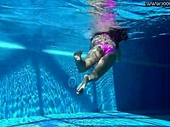 Russian beauty swims in pool