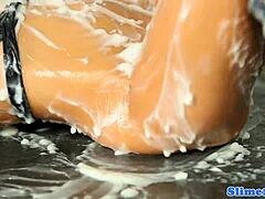 busty babe at gloryhole masturbates while getting bukkake facial