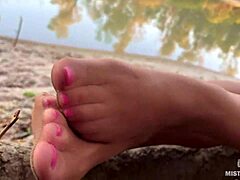 My cute feet in nude tights gently rub together by the autumn river bank.