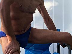 deep pelvic stretching in blue briefs on blue chair late october 2024