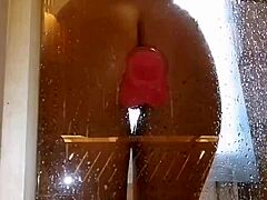 is that girl playing with her pink toy in the shower?