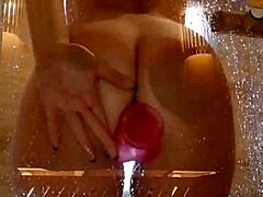 is that girl playing with her pink toy in the shower?