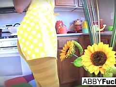 Abigail dresses up in the kitchen with her giant cucumber