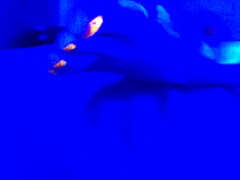 under the blacklight, this chick with black feet gives an intense footjob, sucking on toes and all that fetish stuff
