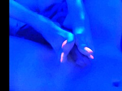 under the blacklight, this chick with black feet gives an intense footjob, sucking on toes and all that fetish stuff