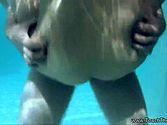 She massages her oiled lover outdoors intimately.