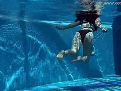 Sheril Blossom, hot Russian teen, strips underwater at beach pool. She shows shaved body in amateur public swim.