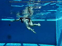 Sheril Blossom, hot Russian teen, strips underwater at beach pool. She shows shaved body in amateur public swim.