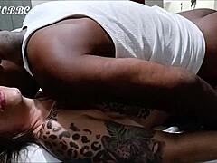 Double nut shared with tattooed brunette in interracial missionary session