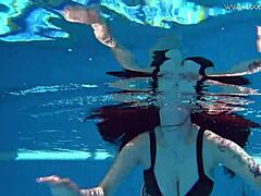 Sheril Blossom, hot Russian teen, strips underwater at beach pool. She shows shaved body in amateur public swim.