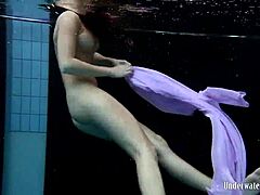 Aneta shows big tits in purple dress underwater in pool