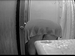 I'm spying on Jennifer bent over in the shower washing her shaved pussy