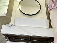 braless hot brunette skinny and horny babe in a pink mini skirt to show her beautiful ass and legs in the bathroom