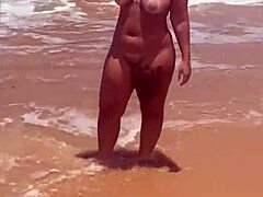 Young African girl flashes naked on beach