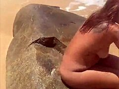 Young African girl flashes naked on beach