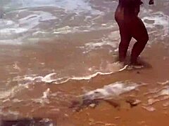 Young African girl flashes naked on beach